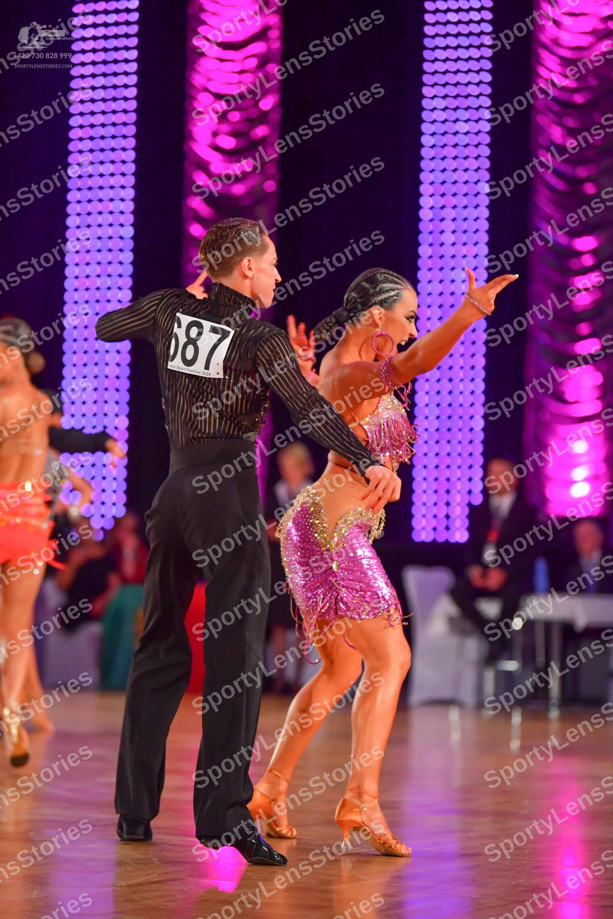 Dancesport competitor #687: Male dancer: black long-sleeved shirt with thin vertical stripes and black trous