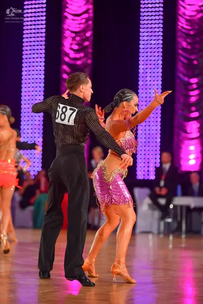 Dancesport competitor #687: Male dancer: black long-sleeved shirt with thin vertical stripes and black trous