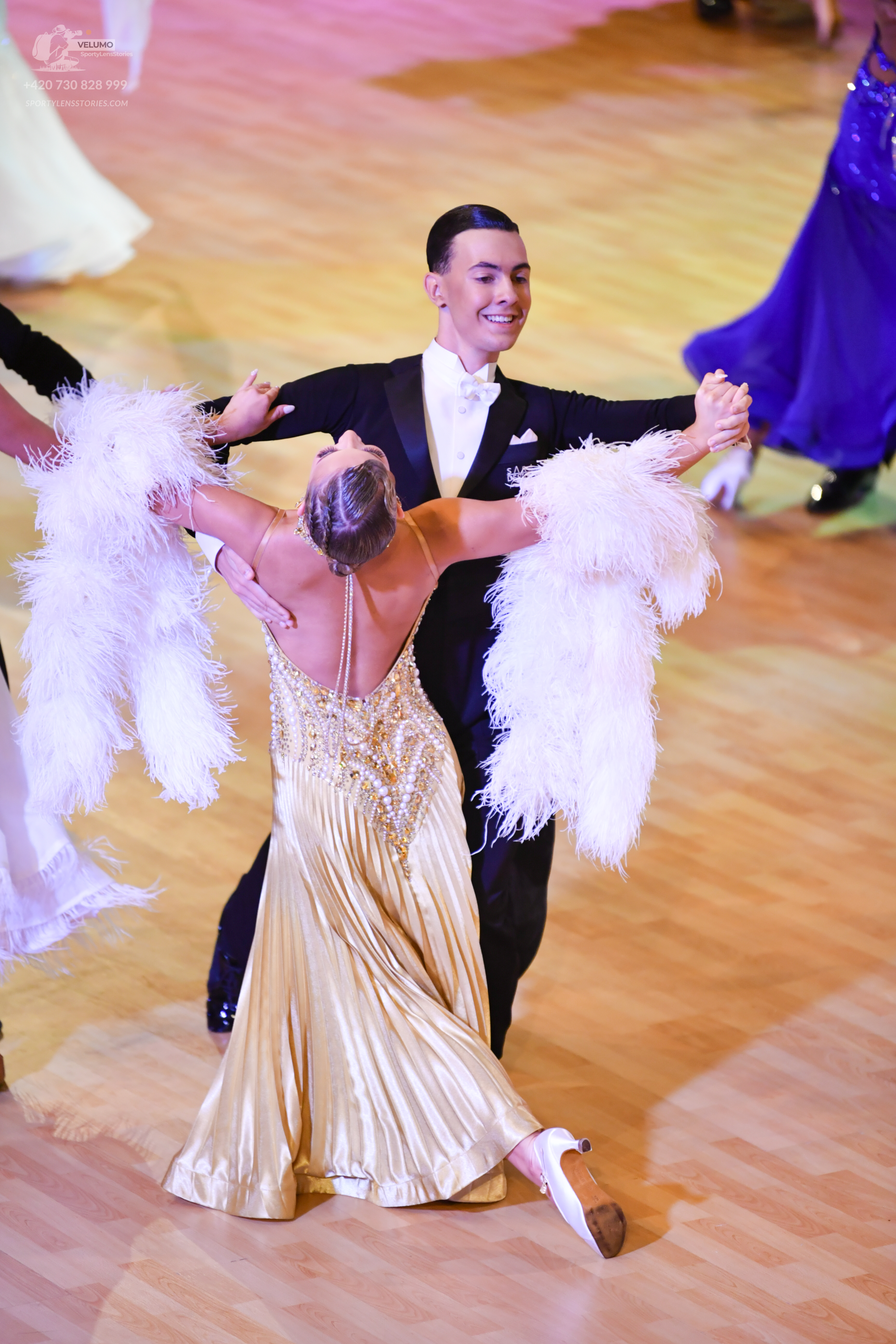 Dancesport competitor: Male dancer: black suit with a white shirt and white bow tie