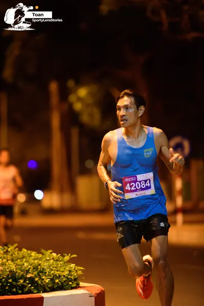 Marathon runner #42084: Runner 1: blue tank top, black shorts, orange shoes