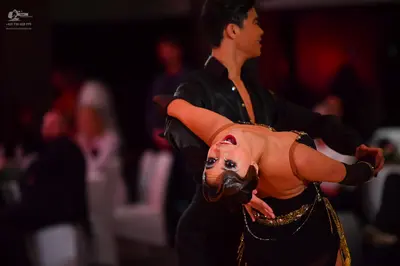 Dancesport competitor: Male dancer: black long-sleeved shirt