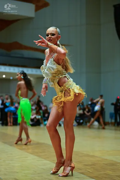 Dancesport competitor: Female dancer: gold sequin latin dress with fringe