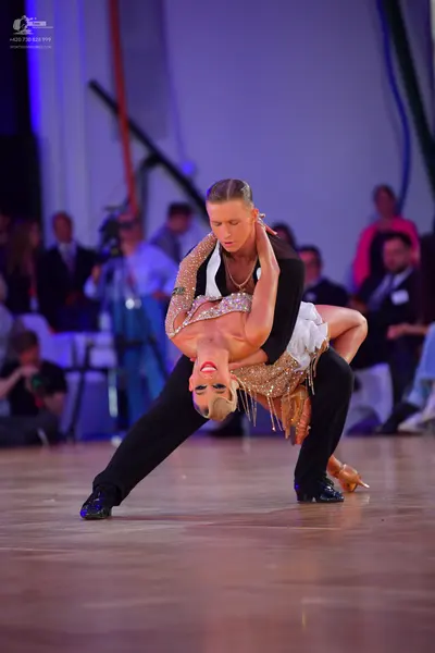 Dancesport competitor: Male dancer: black and white top with black trousers and black dance shoes