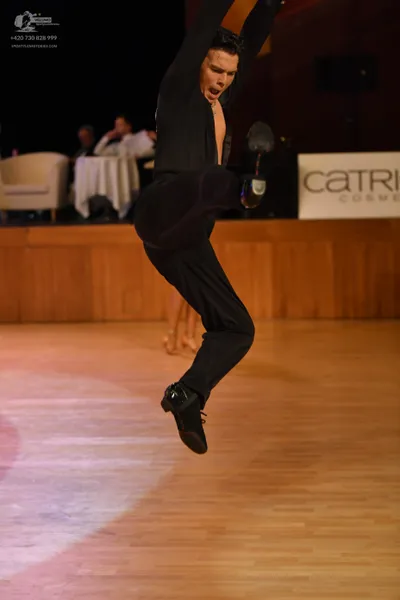 Dancesport competitor: Male dancer: black long-sleeved top and black trousers
