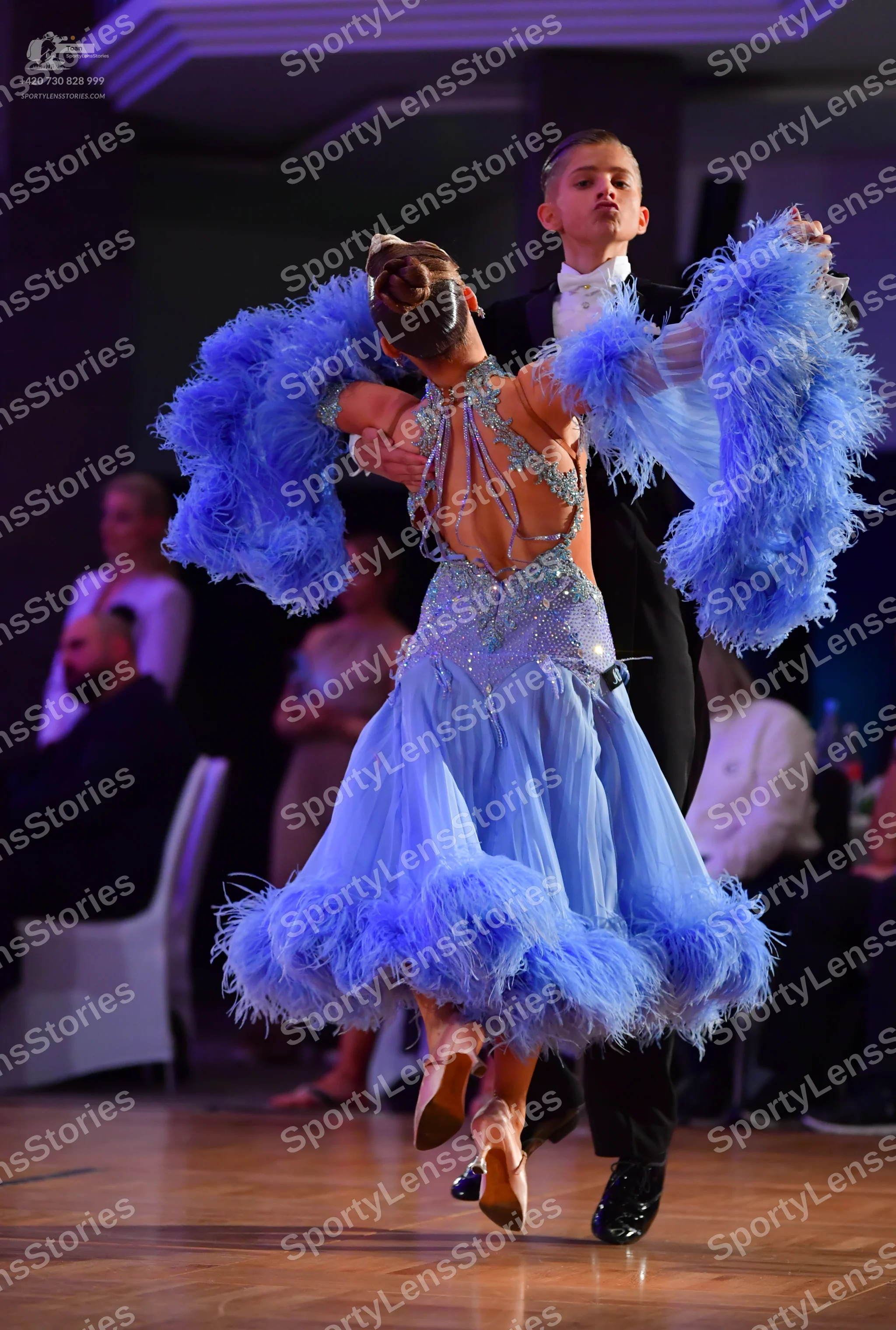 Dancesport competitor: Female dancer: light blue dress with a sequined bodice and voluminous light blue