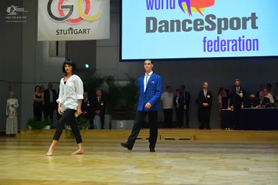 Dancesport competitor: Female dancer: white long-sleeved shirt and black leggings