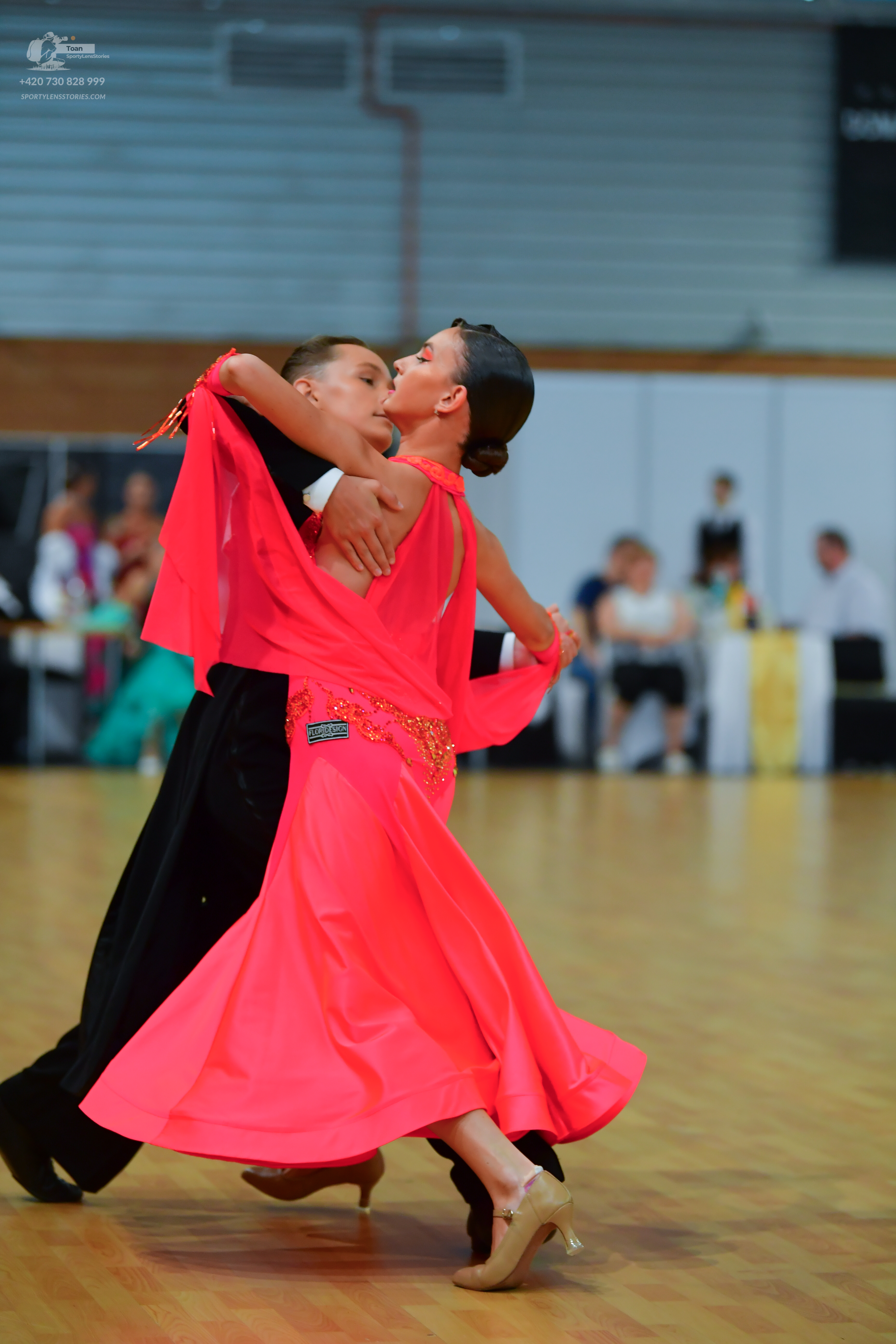 Dancesport competitor: ** Red Latin Dress
*   **Fabric:** Likely satin or a similar flowy material – ap