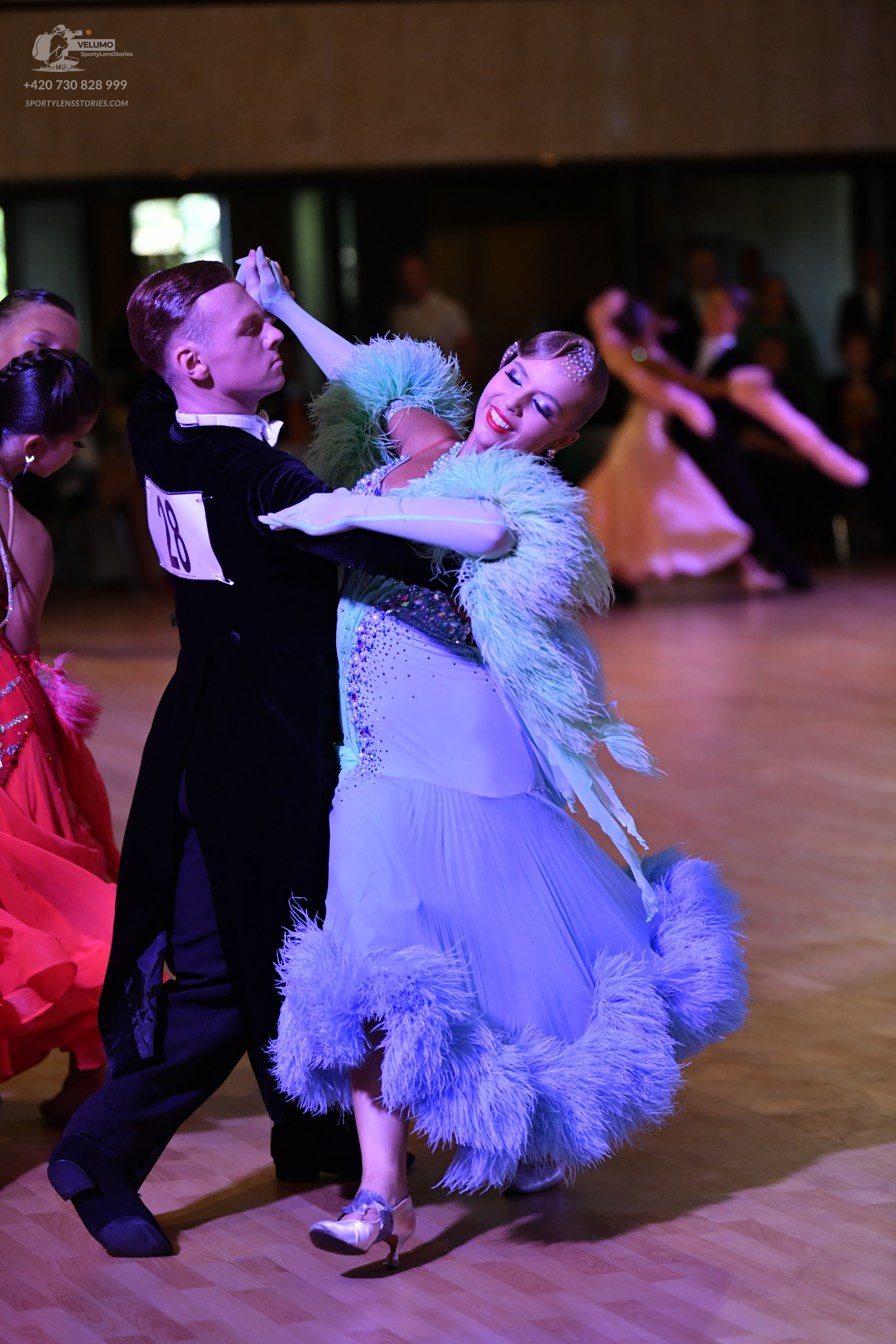 Dancesport competitor: **
*   **Male Dancer 1:** Costume: Black suit with a wide, sequined lapel