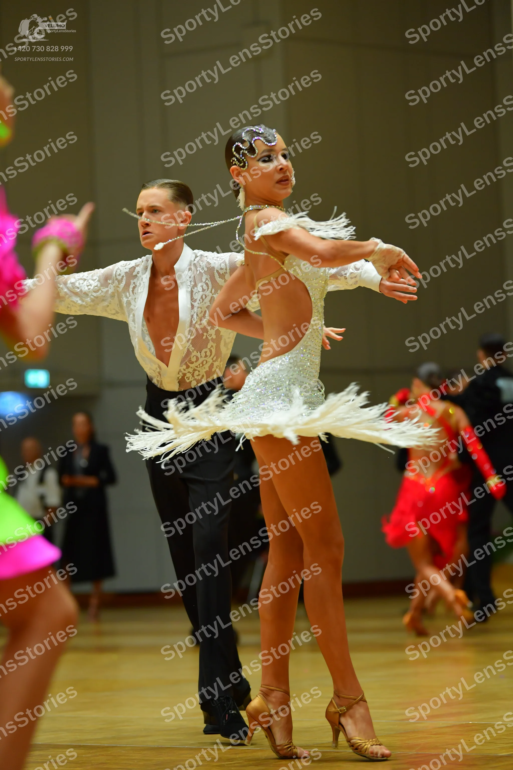 Dancesport competitor: Male dancer: white lace long-sleeved shirt and black trousers