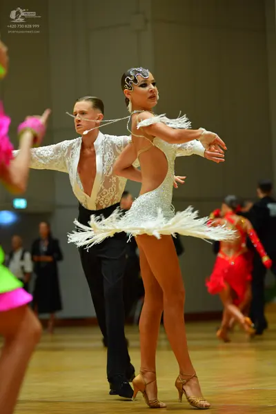 Dancesport competitor: Male dancer: white lace long-sleeved shirt and black trousers