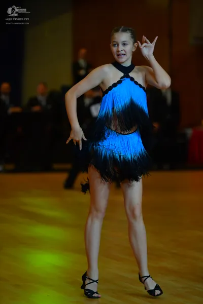 Dancesport competitor: Female dancer: blue and black latin dress with fringe and black halter neck