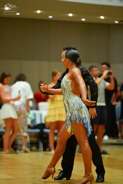 Dancesport competitor: Female dancer: light turquoise/pale blue latin dress with sequins and fringe