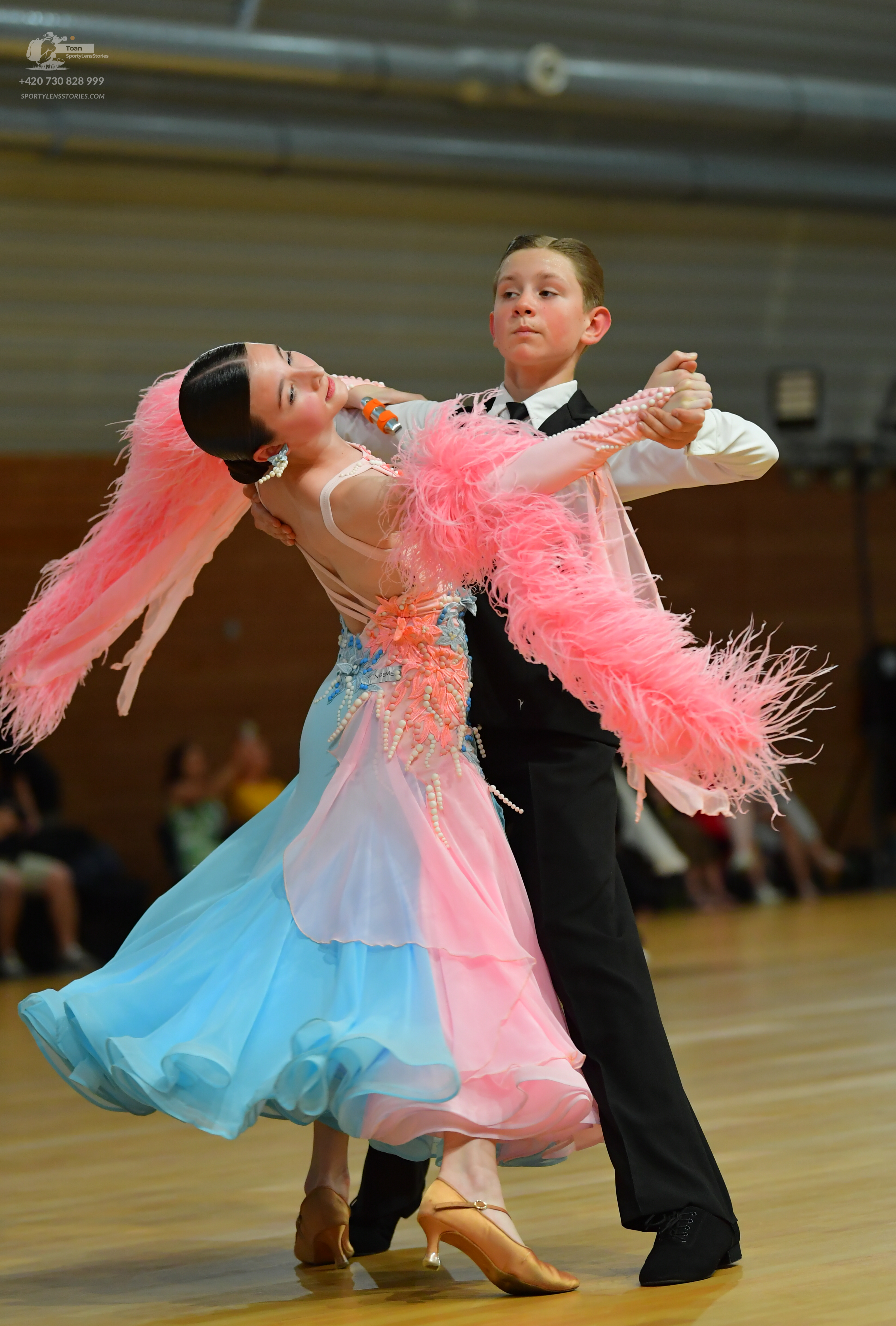 Dancesport competitor: ** Pink and blue Latin dress
*   **Colors:** Predominantly pink with light blue 