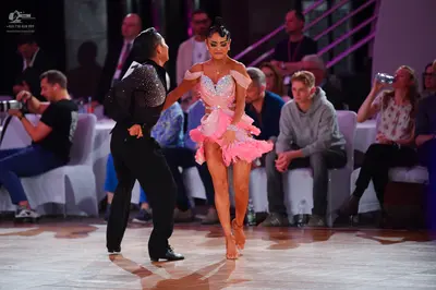 Dancesport competitor: Male dancer: black long-sleeved top with sequin detailing on the back and should