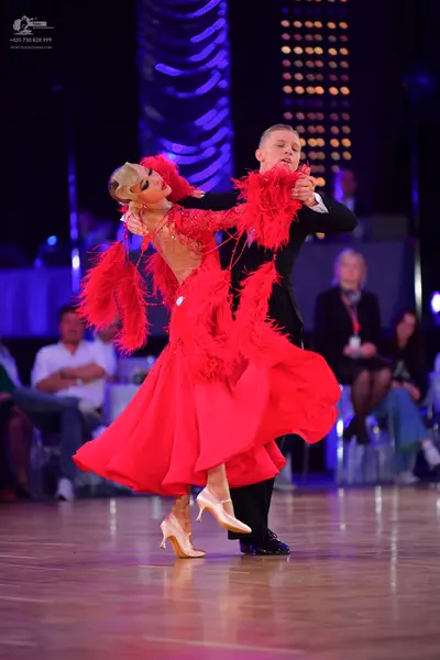 Dancesport competitor: Male dancer: black suit with a white shirt