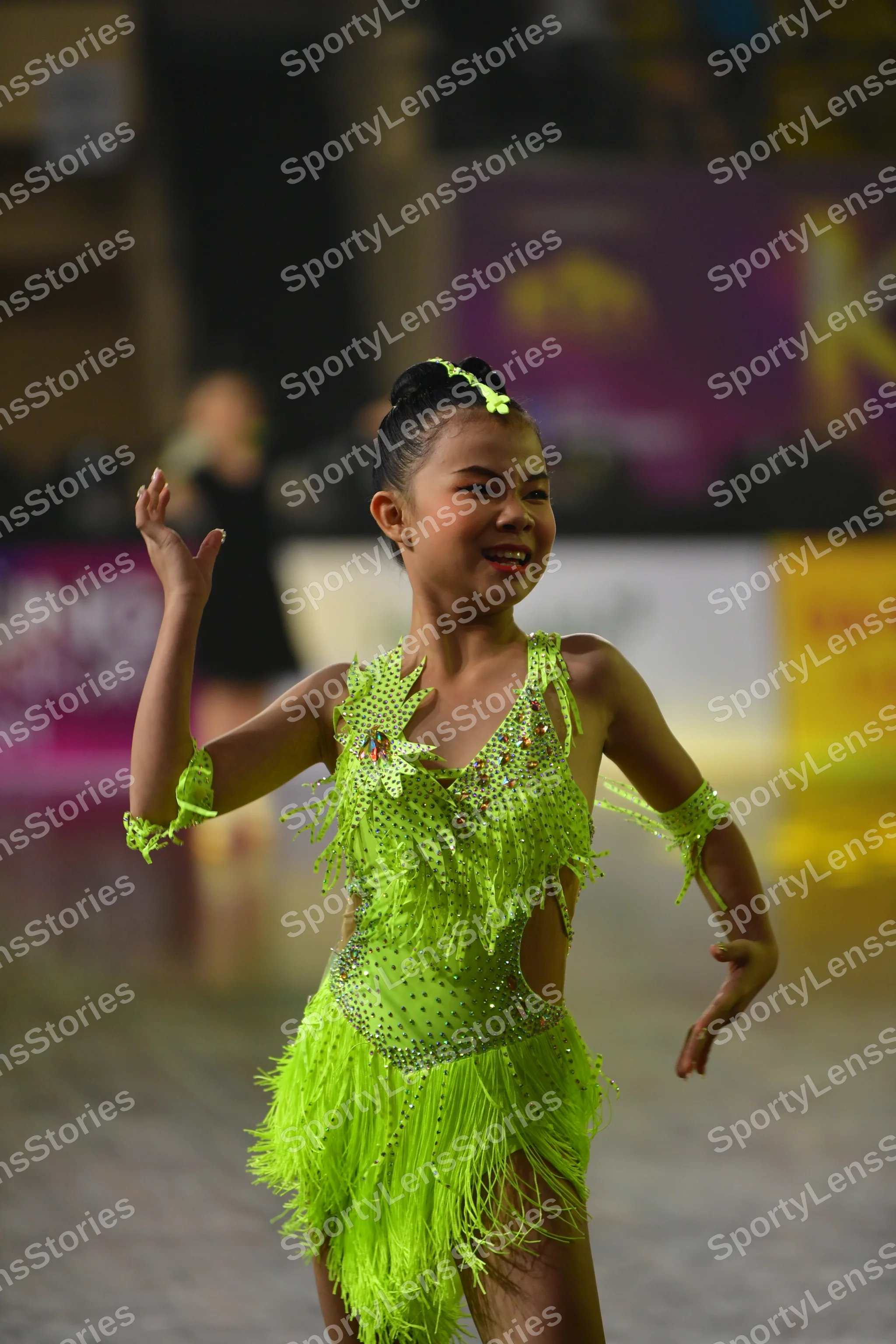 Dancesport competitor: Female dancer: lime green latin dress with fringe and sequins, with matching arm