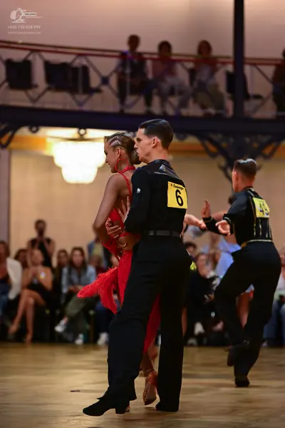 Dancesport competitor: Male dancer: black shirt and black trousers