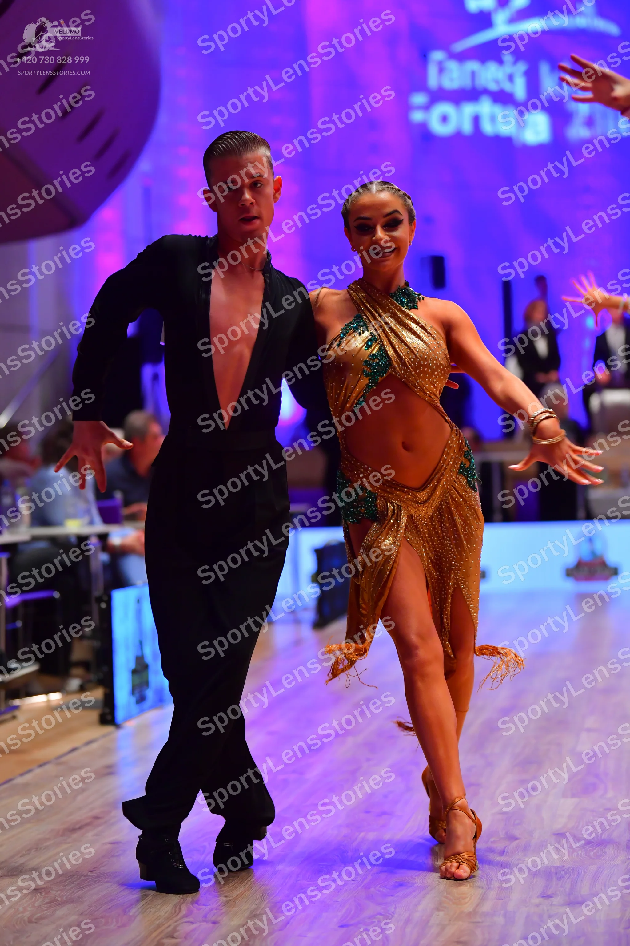 Dancesport competitor: Male dancer: black long-sleeved shirt with a deep V-neck and black trousers