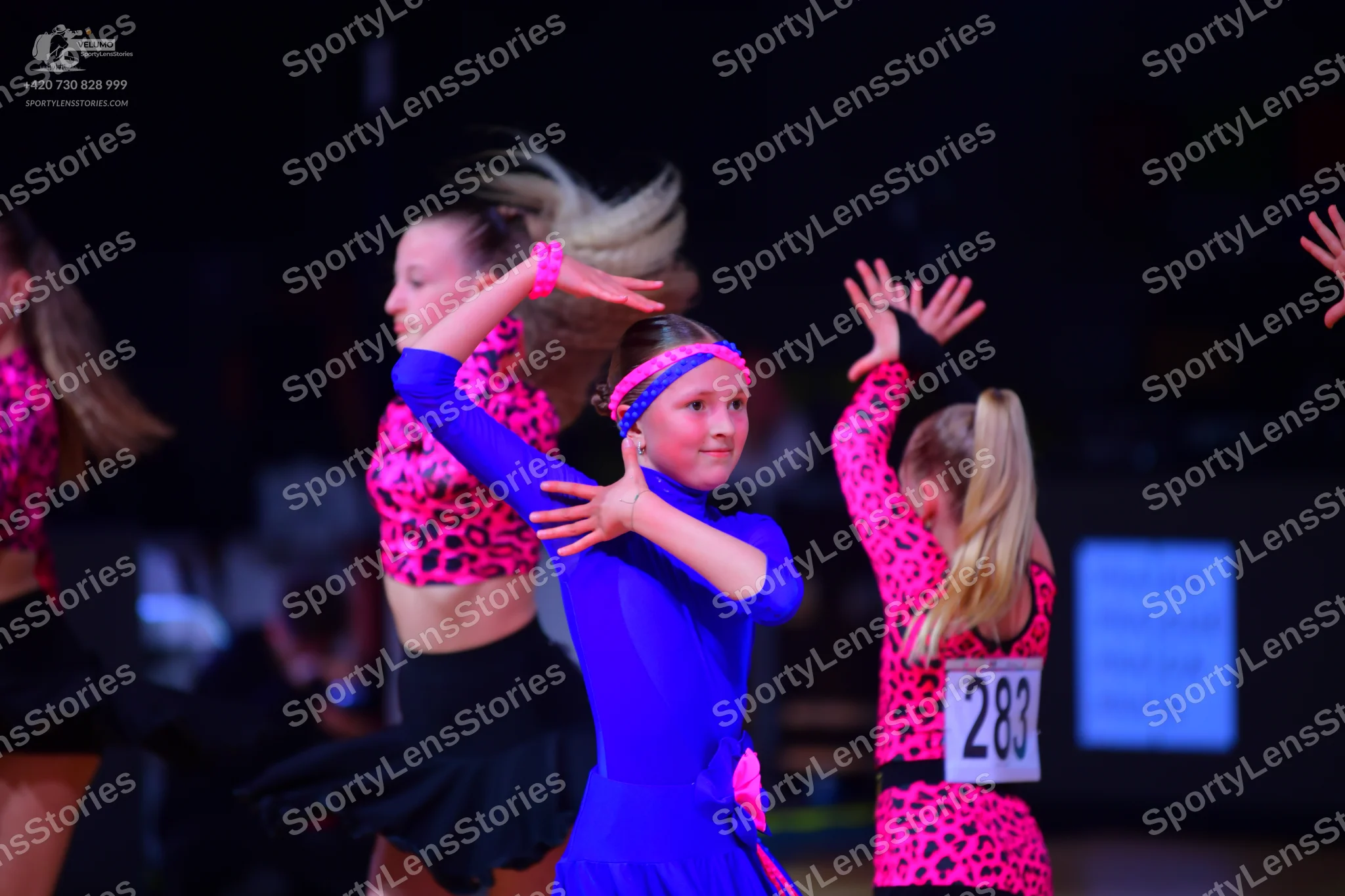Dancesport competitor: Female dancer: pink and black leopard print top with black skirt