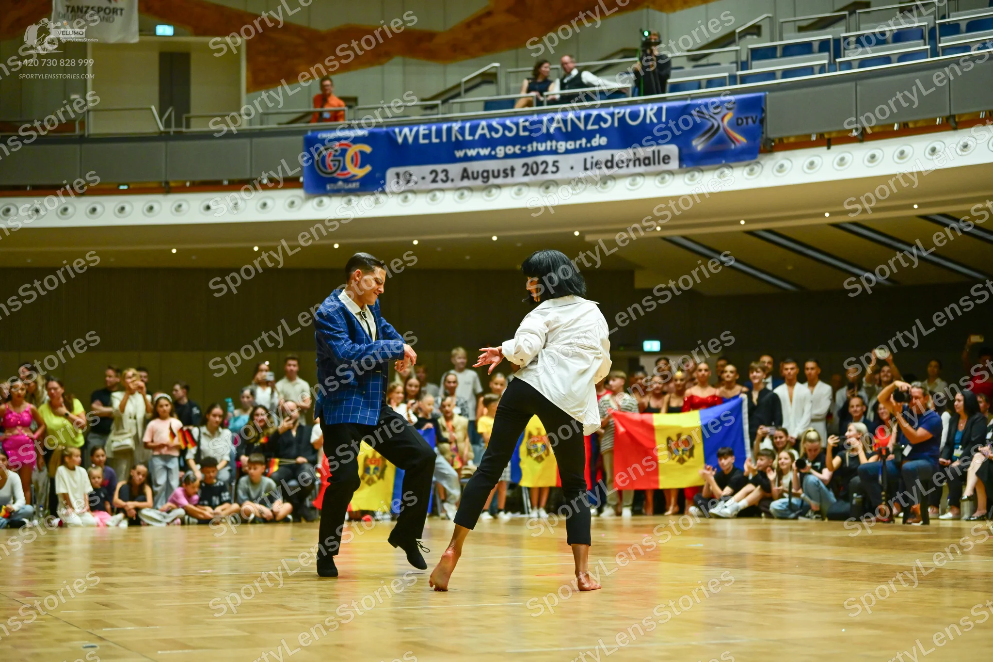 Dancesport competitor: Male dancer: blue suit jacket and black trousers