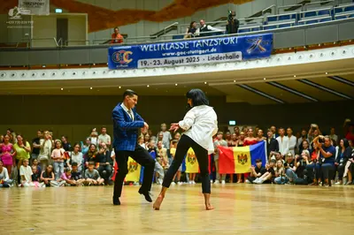 Dancesport competitor: Male dancer: blue suit jacket and black trousers