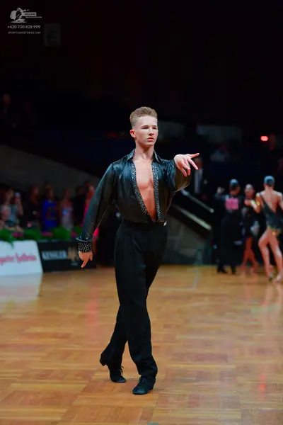 Dancesport competitor: Male dancer: black shirt with small rhinestone embellishments along the front op