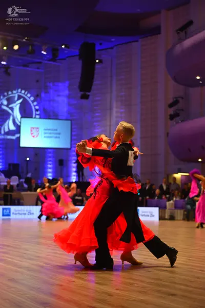 Dancesport competitor: Male dancer: black suit and black trousers