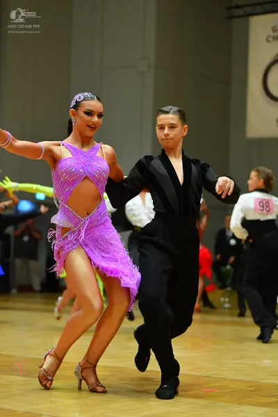 Dancesport competitor #98: Female dancer: purple latin dress with sequins and fringe, and a matching purple