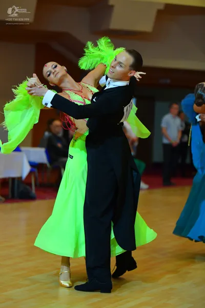 Dancesport competitor #73: Female dancer: bright lime green ballroom dress with large lime green feather-li