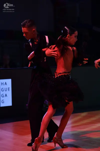 Dancesport competitor: Male dancer: black long-sleeved top and black trousers