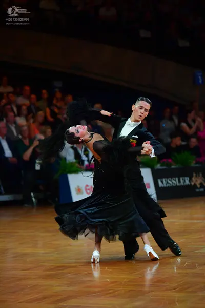 Dancesport competitor: Male dancer: black suit with a white shirt and white bow tie