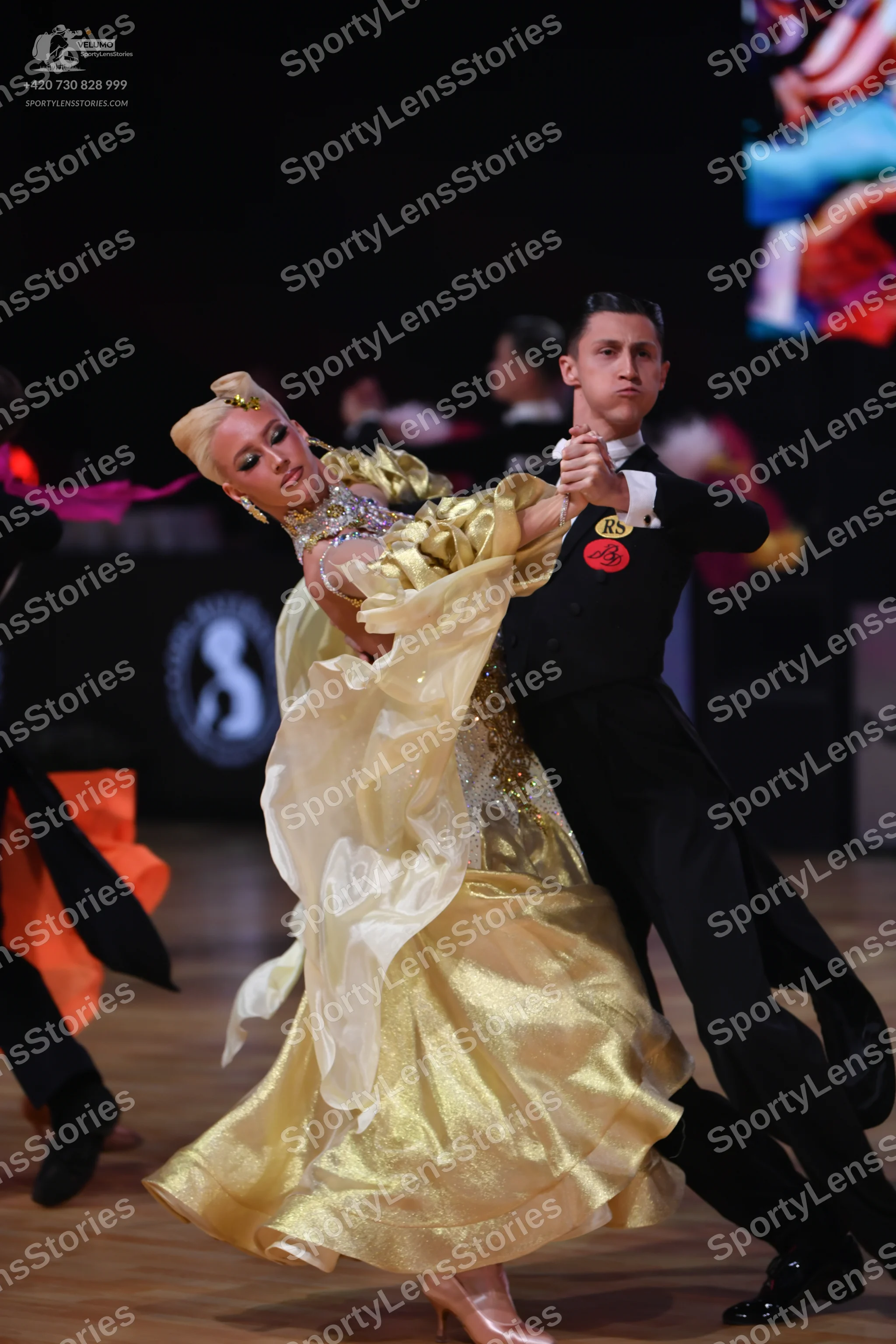 Dancesport competitor: Male dancer: black suit, white shirt, and black bow tie