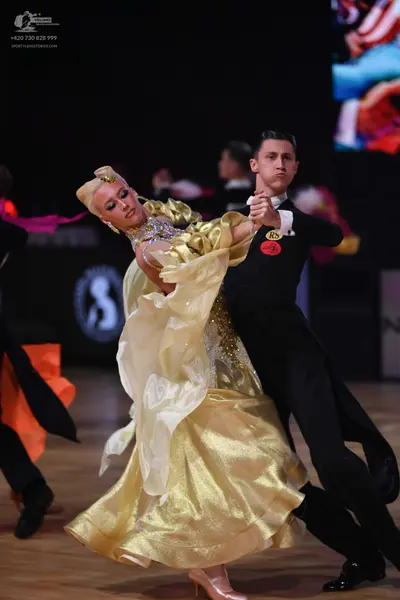 Dancesport competitor: Male dancer: black suit, white shirt, and black bow tie