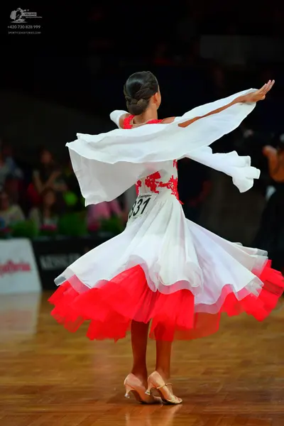 Dancesport competitor: Female dancer: white and red Latin dance dress with red lace detailing on the bo
