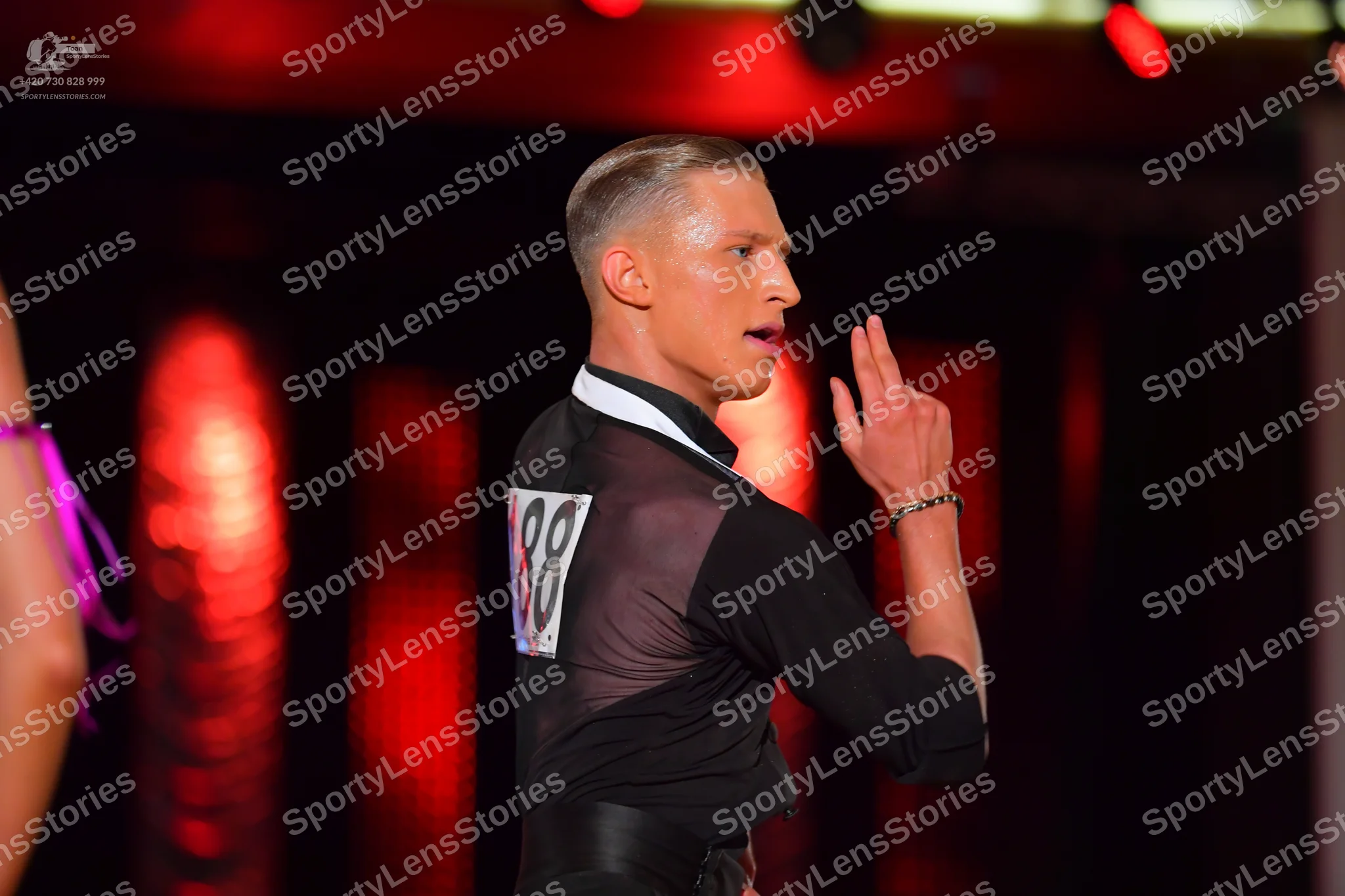 Dancesport competitor #88: Male dancer: black long-sleeved top with a mesh panel on the shoulder and back, 