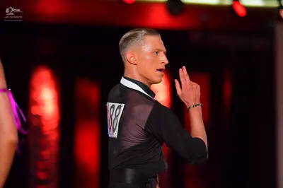 Dancesport competitor #88: Male dancer: black long-sleeved top with a mesh panel on the shoulder and back, 