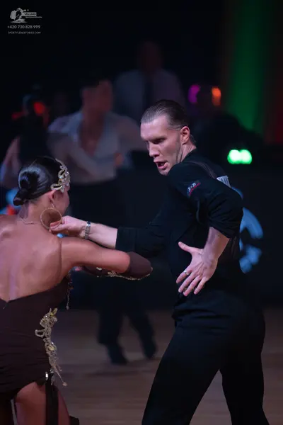 Dancesport competitor: Male dancer: black long-sleeve shirt and black trousers