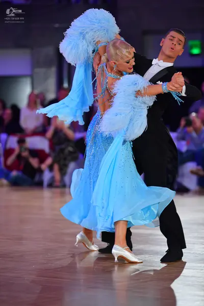Dancesport competitor: Male dancer: black suit with a white shirt and white bow tie