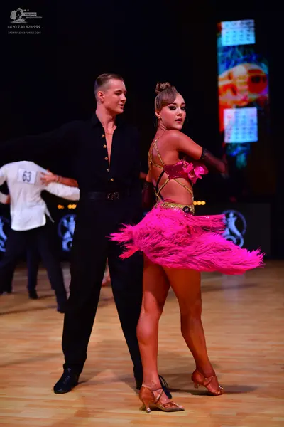 Dancesport competitor: Male dancer: black shirt with gold buttons and black trousers