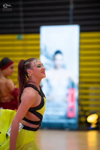 Dancesport competitor: ** Yellow, body-hugging, short sequin dress