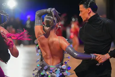 Dancesport competitor: Male dancer: black long-sleeved top