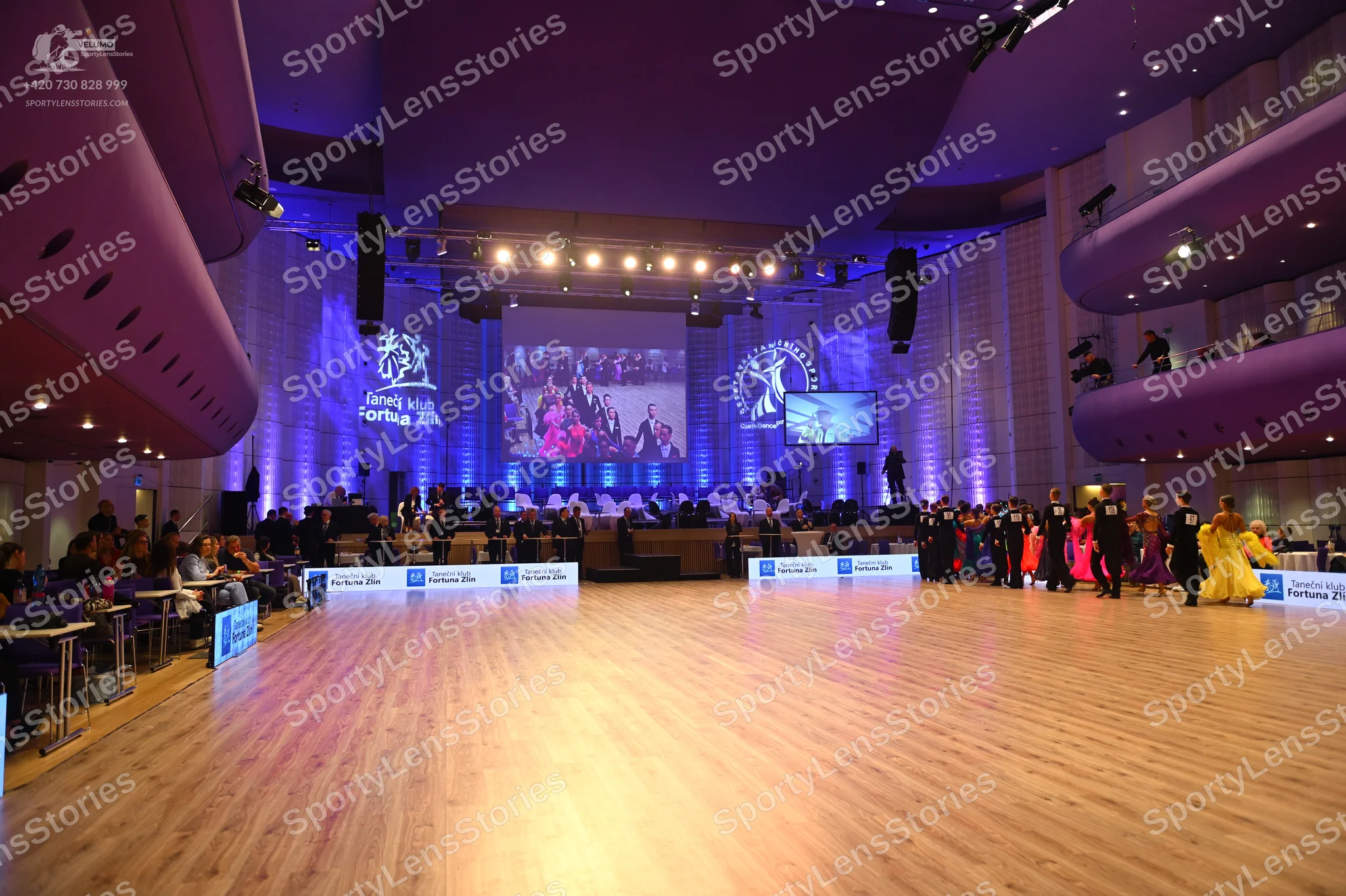 Dancesport competitor: Female dancer: large, voluminous bright yellow or gold ballgown