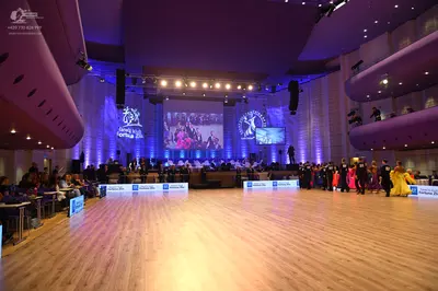 Dancesport competitor: Female dancer: large, voluminous bright yellow or gold ballgown