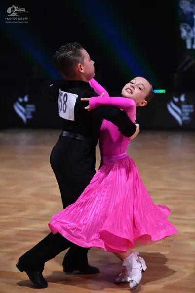 Dancesport competitor: Male dancer: black long-sleeved shirt and black trousers