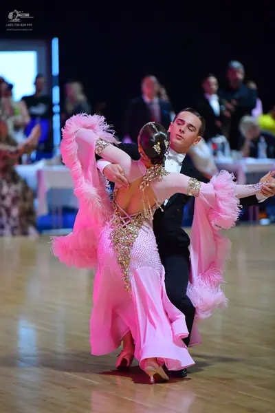 Dancesport competitor: Male dancer: black suit with a white shirt and white bow tie