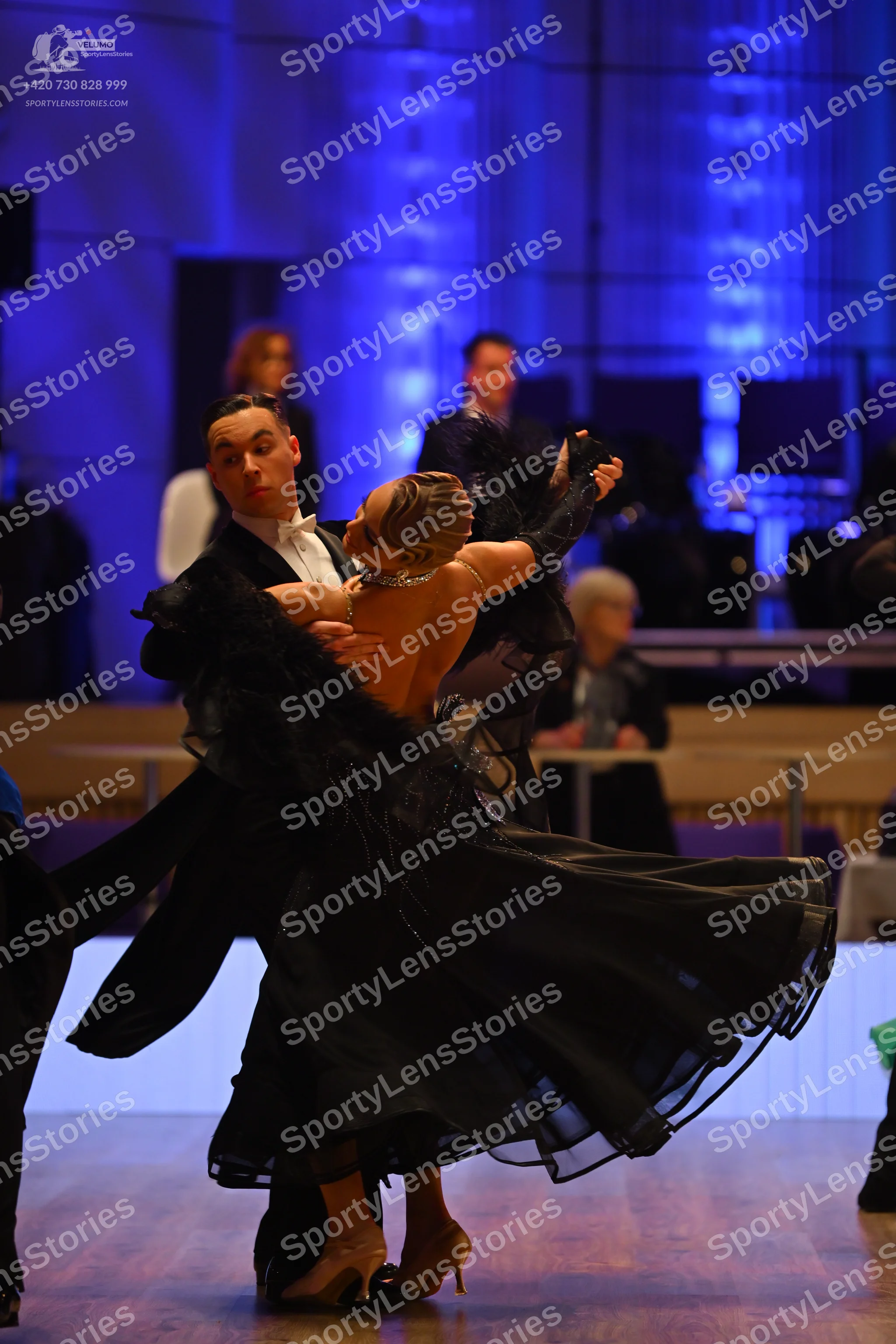 Dancesport competitor: Male dancer: black suit with a white shirt and white bow tie