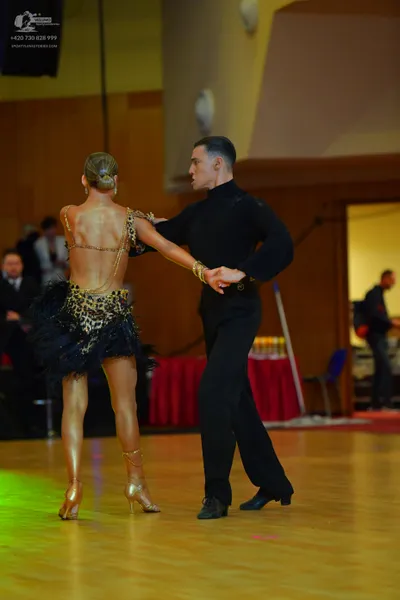 Dancesport competitor: Female dancer: leopard print latin dress with a black tulle skirt and thin strap