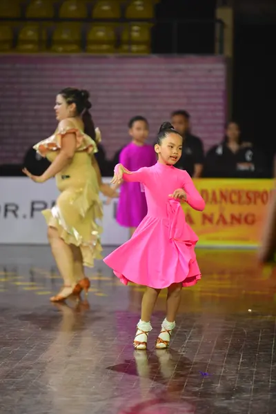 Dancesport competitor: Female dancer: gold latin dress
