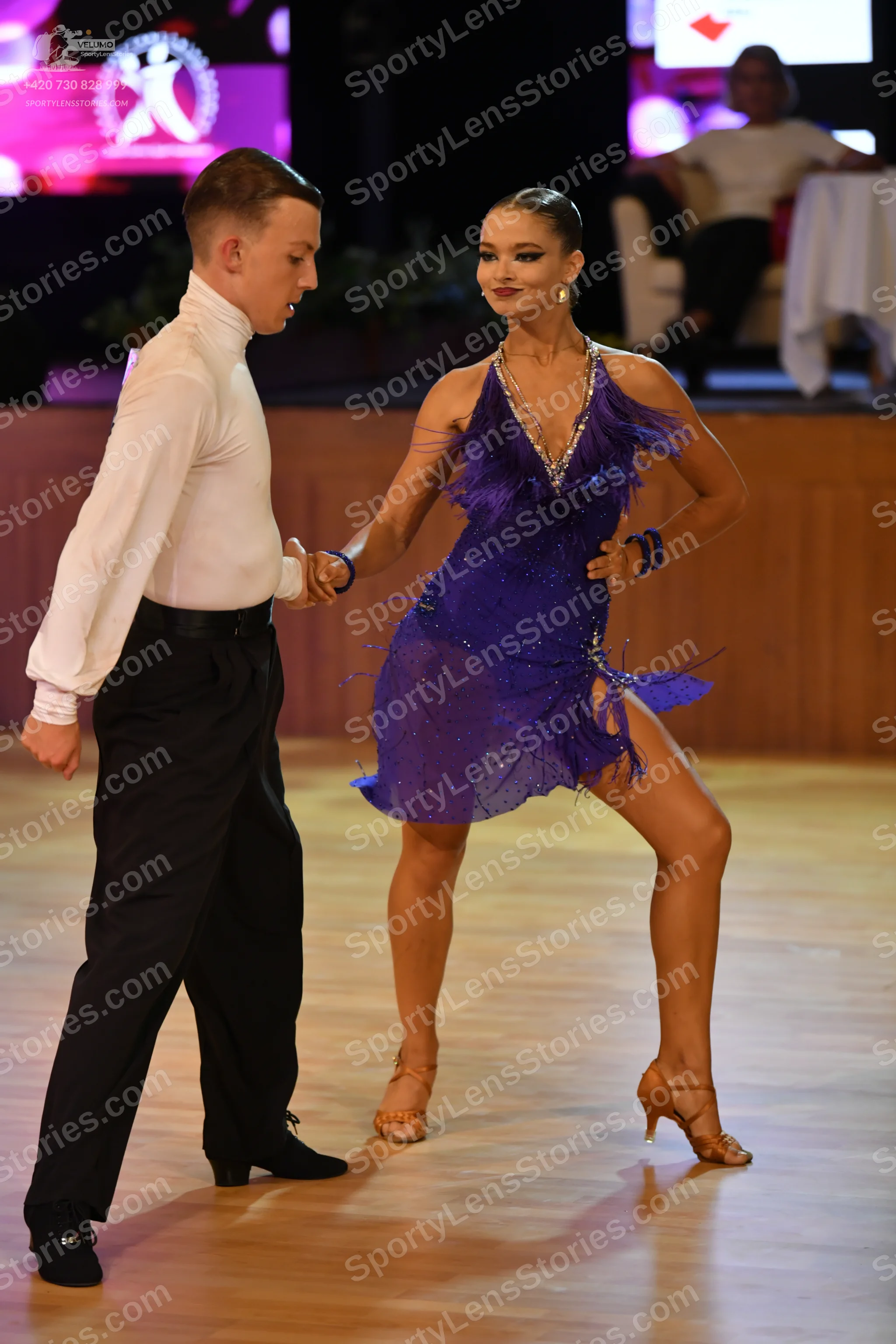 Dancesport competitor: Male:** Black tailsuit with sequin lapels and black shoes