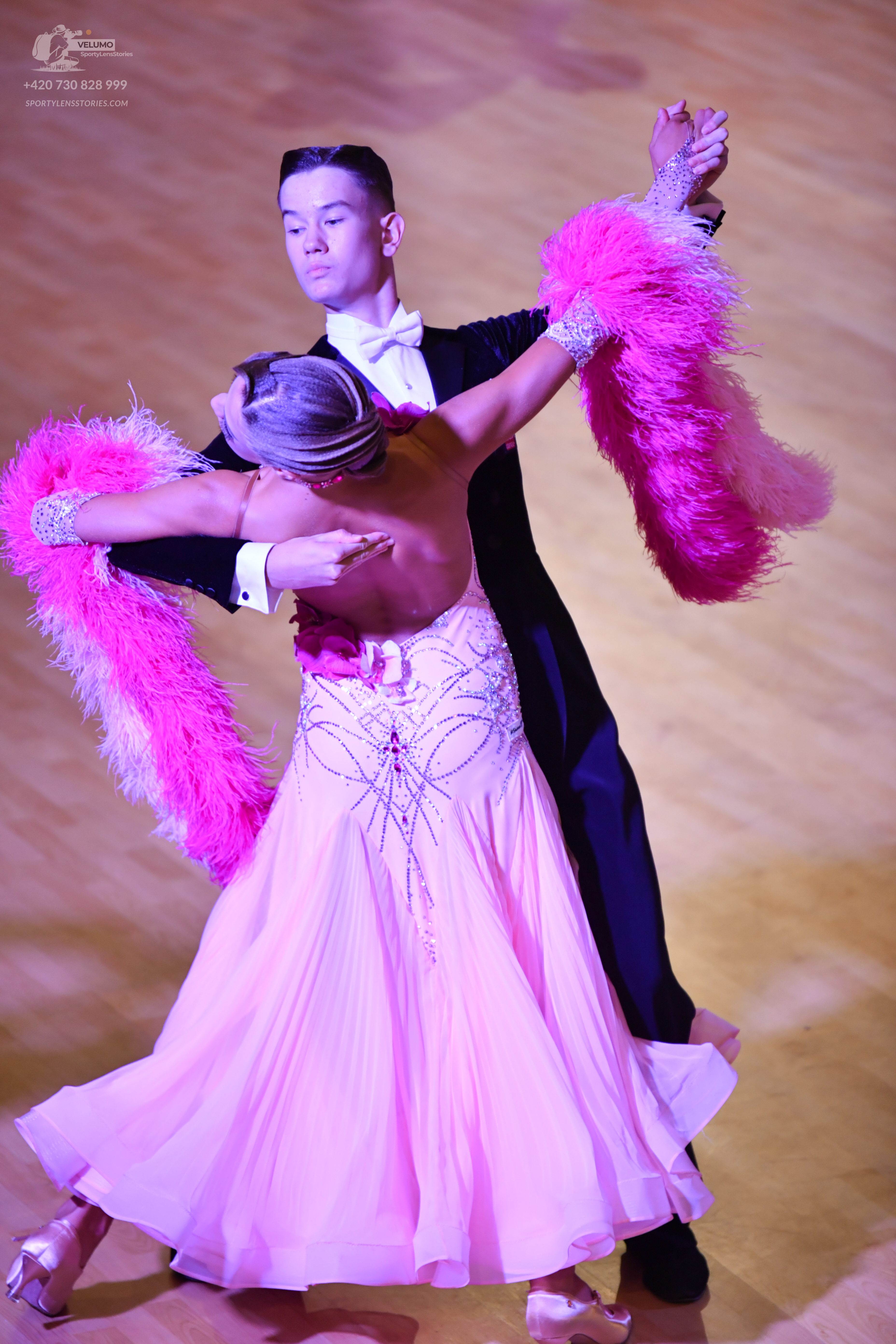 Dancesport competitor: Male:** Black tail suit with iridescent sequins on the lapels and sleeves